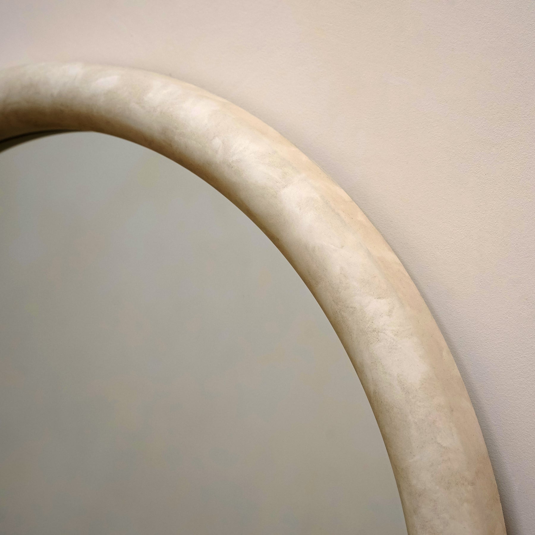 Closeup of Full length arched concrete mirror