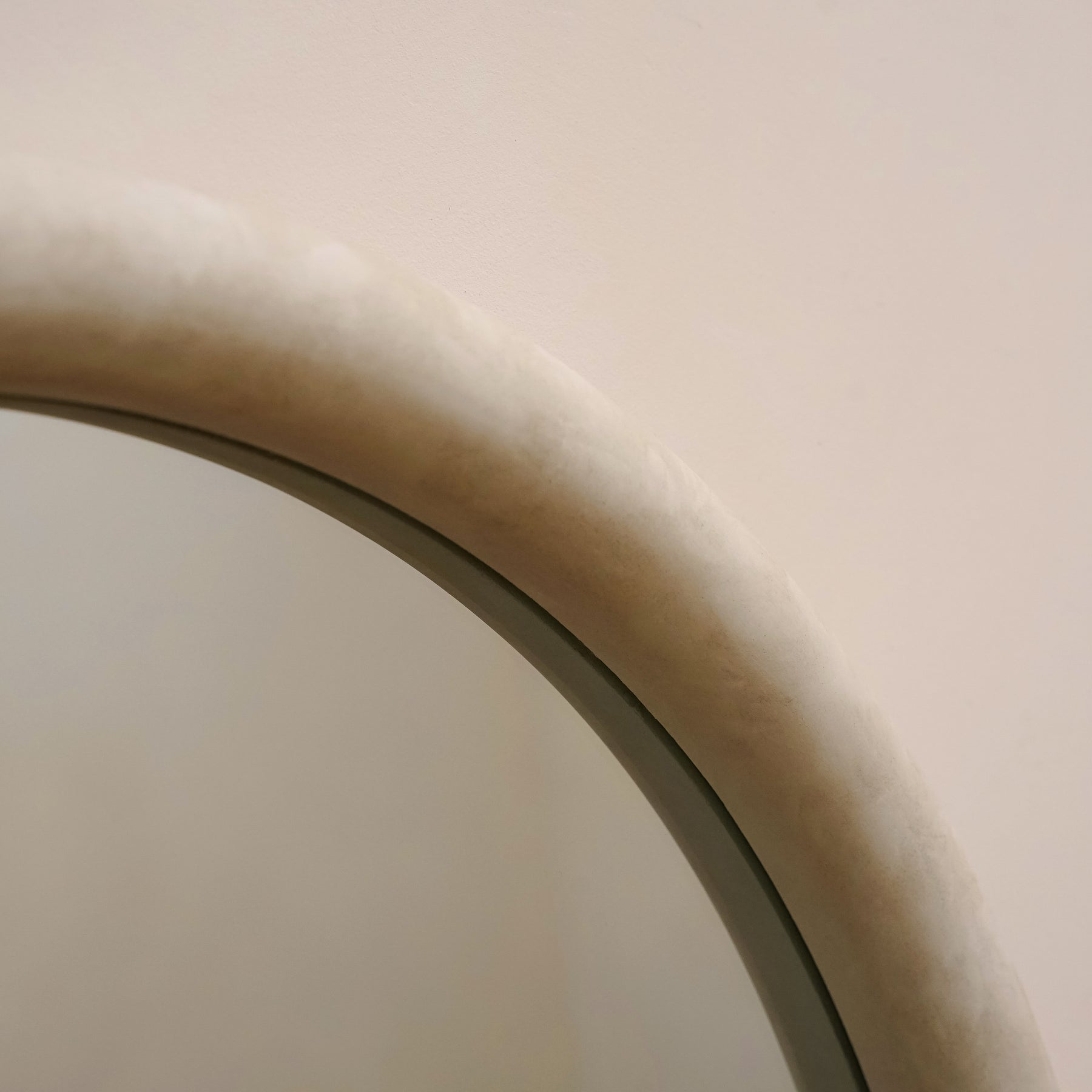 Closeup of Full length arched concrete mirror