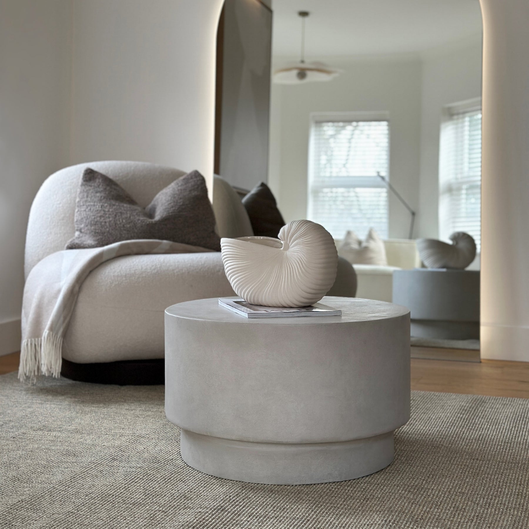 Minimalist concrete round coffee table displayed in living room
