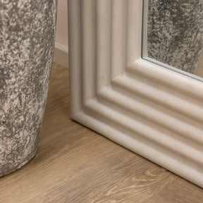 Full length ribbed concrete mirror closeup with vase