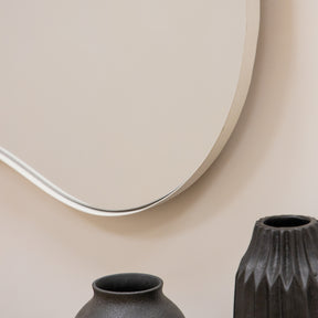 Ecru metal pond shaped irregular wall mirror closeup