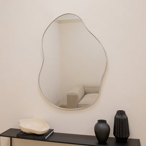 Ecru metal pond shaped irregular wall mirror displayed vertically
