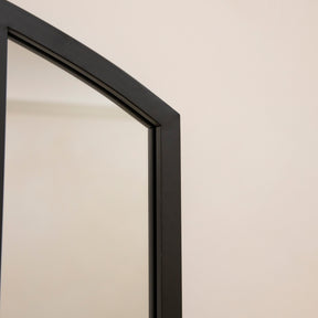 Closeup of Full length black metal window mirror corner