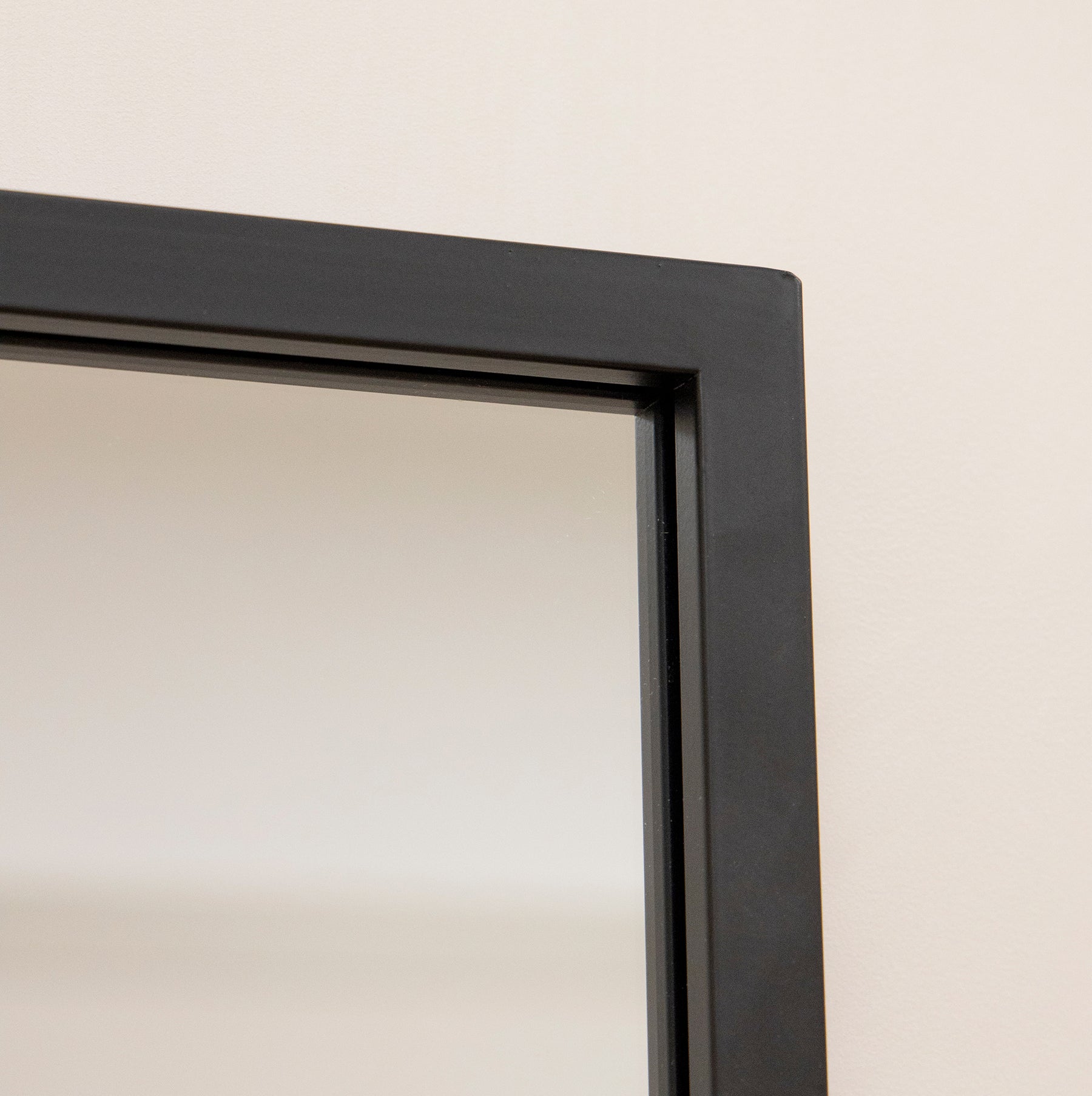 Detail shot of Large black industrial metal window mirror