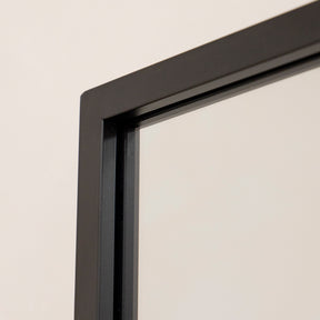 Closeup of Large black industrial metal window mirror