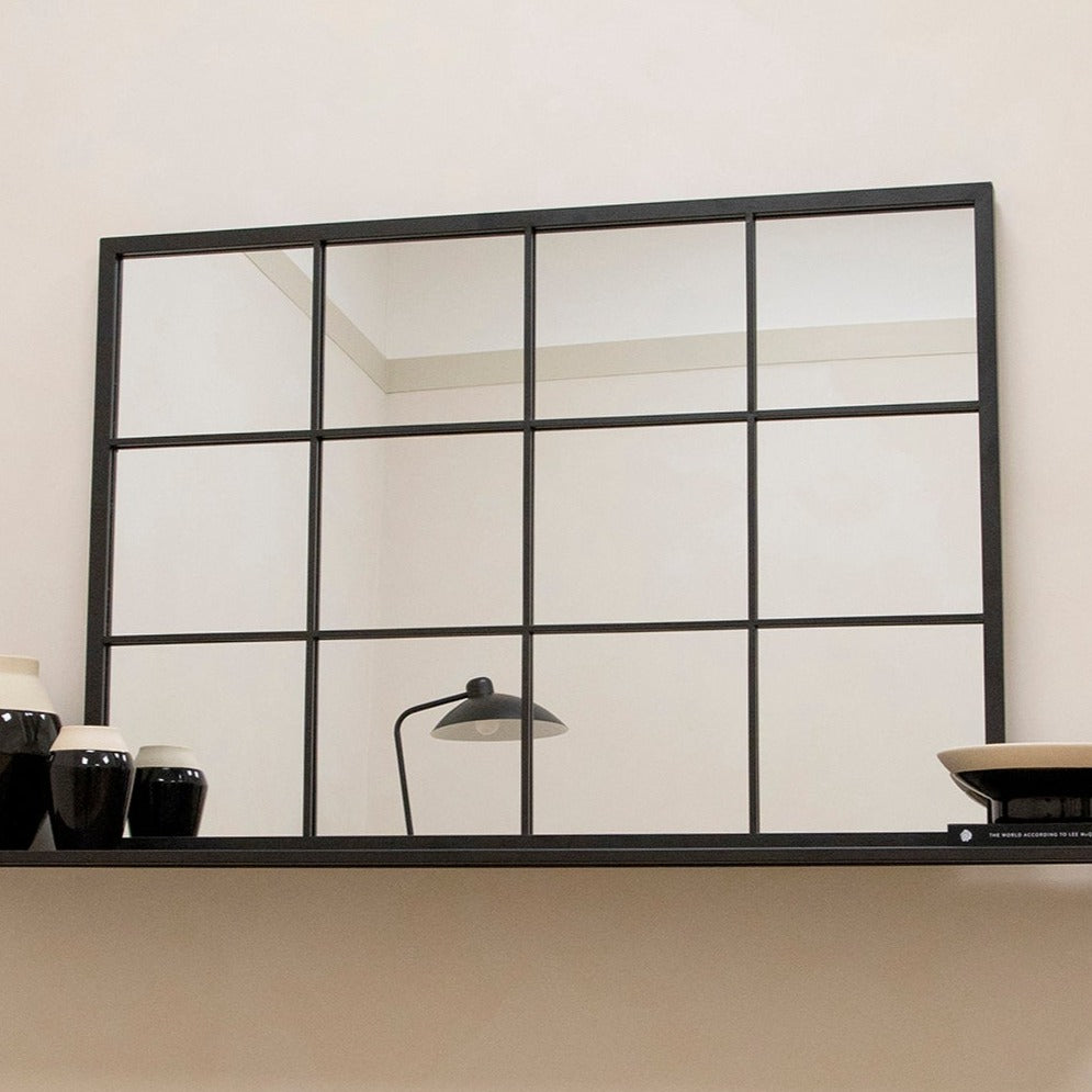 Large black industrial metal window mirror displayed horizontally