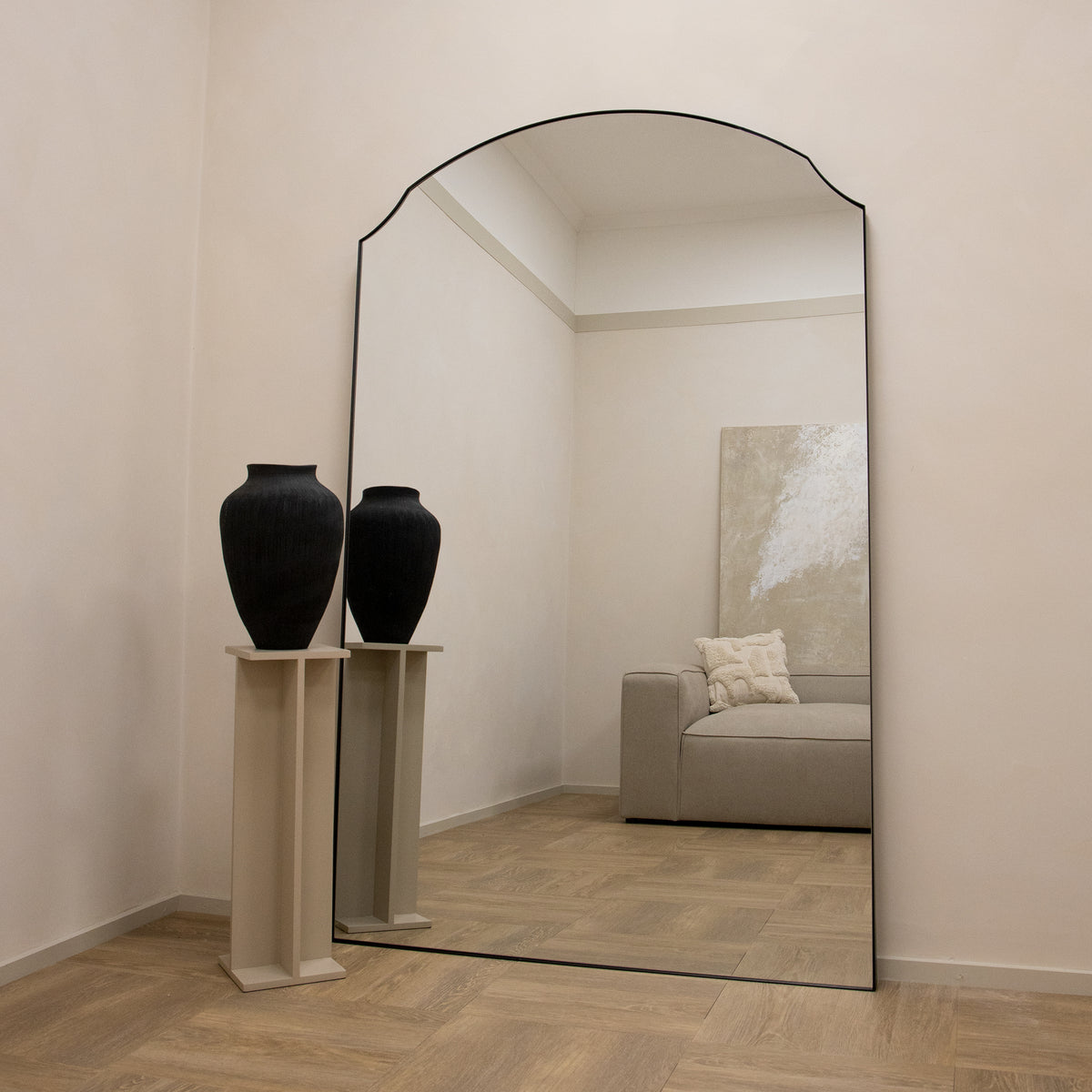 Black Full Length Arched Metal Mirror leaning against wall