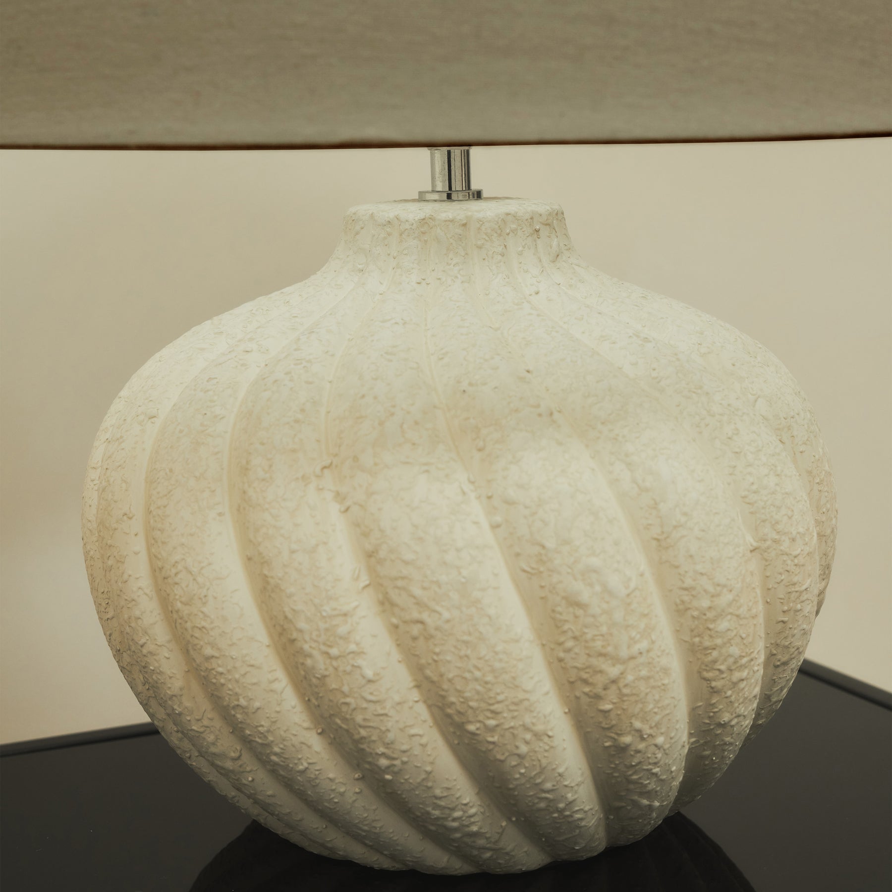 Textured ceramic based table lamp beige shade detail shot
