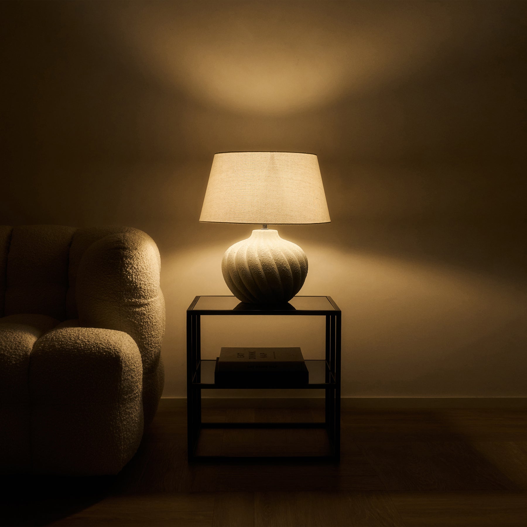 Textured ceramic based table lamp natural shade emitting warm lighting
