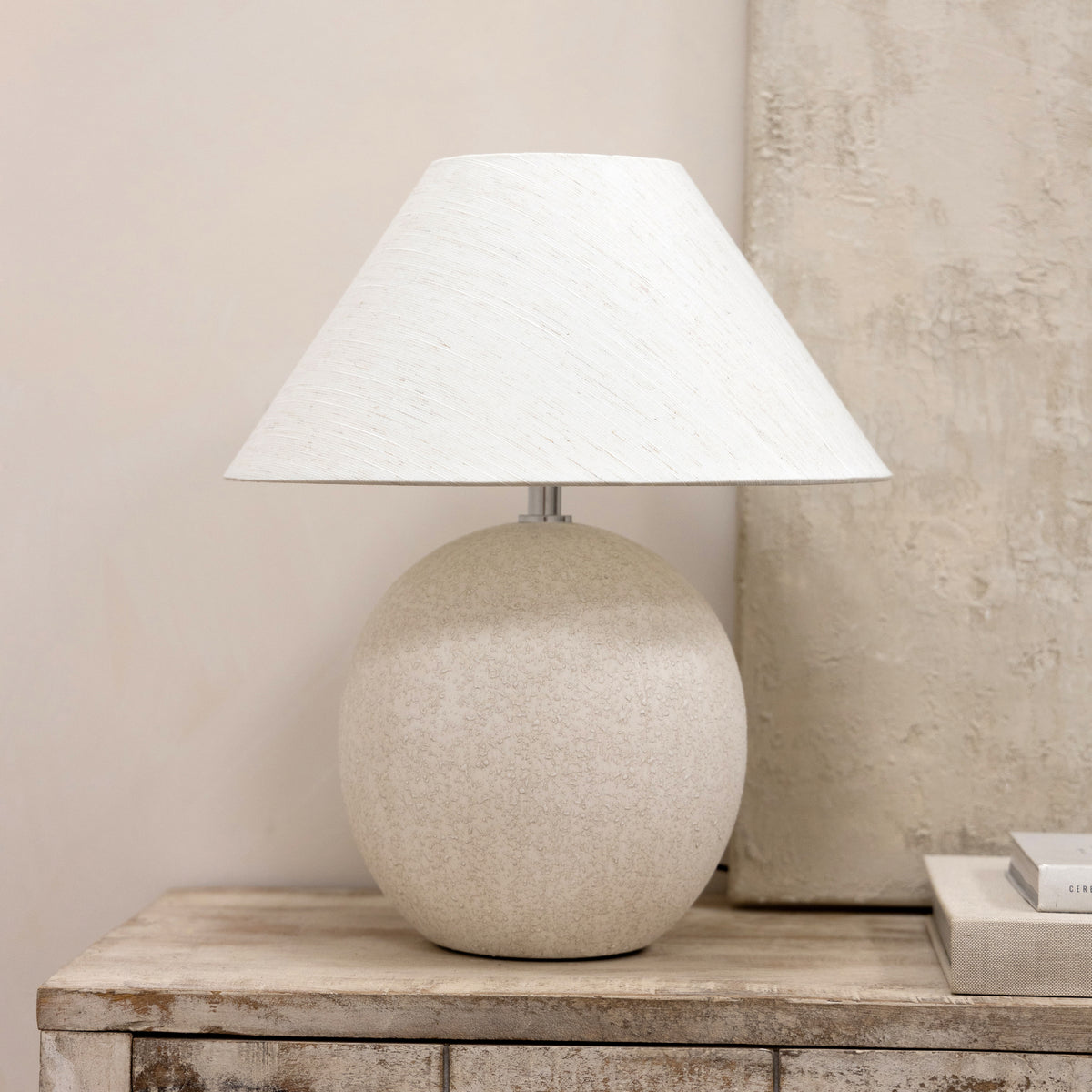 Stone ceramic coolie shade table lamp on console table