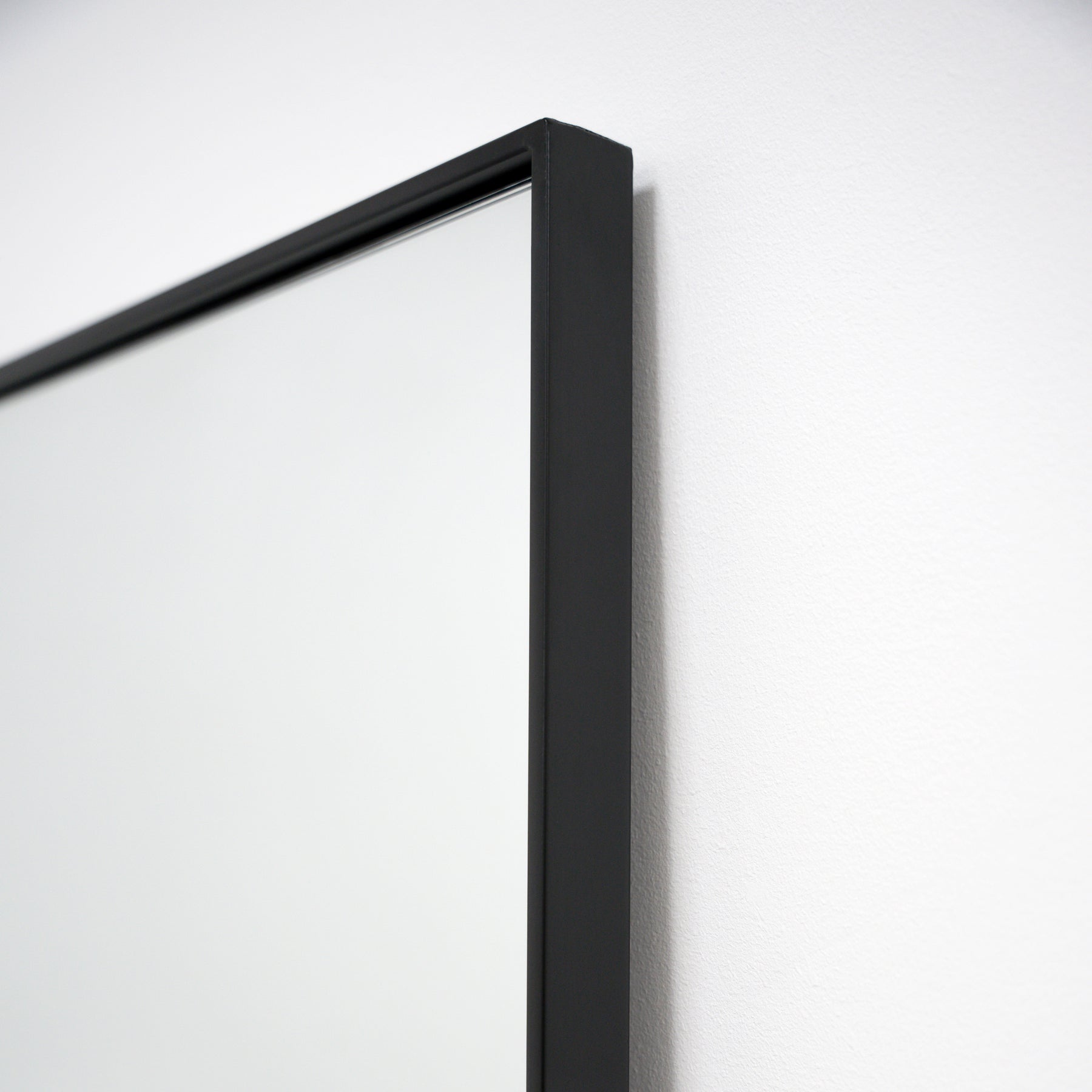 Closeup of Full Length Black Curved Metal Extra Large Mirror corner