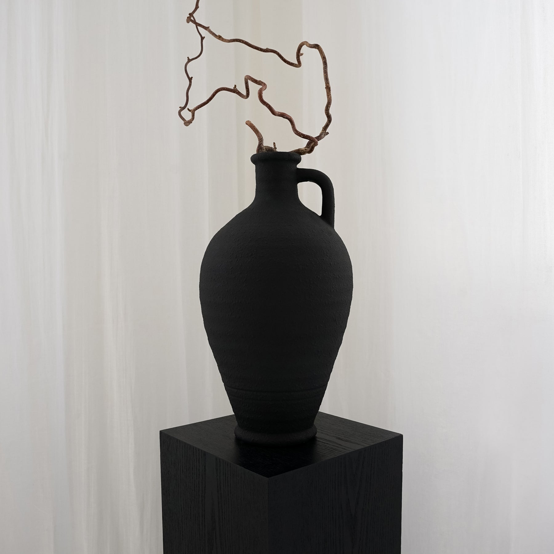 Alternate shot of Black Textured Ceramic Large Vase on plinth