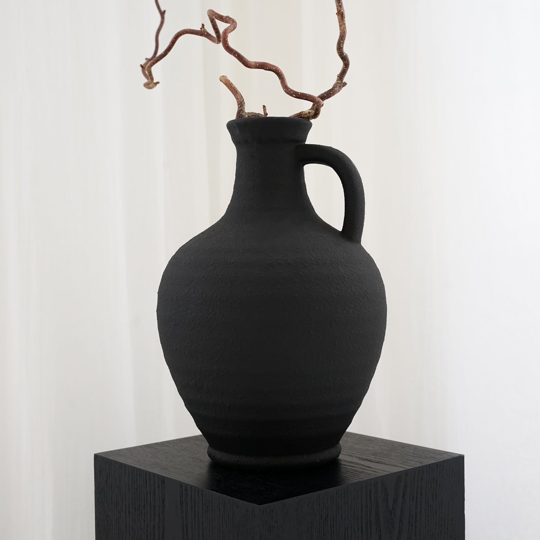 Alternate shot of Black Textured Ceramic Small Vase on plinth