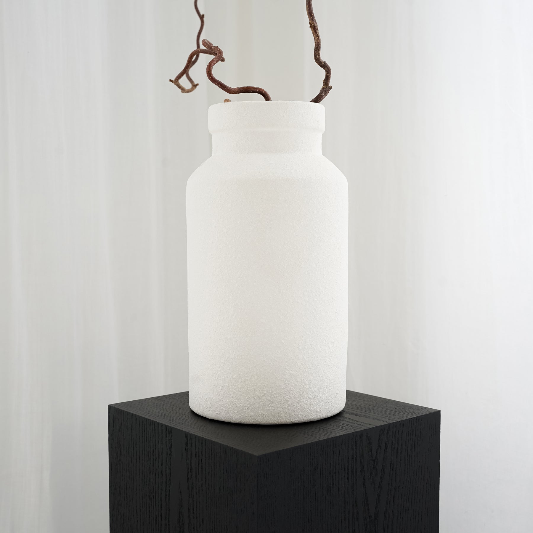 White textured ceramic small vase on pedestal