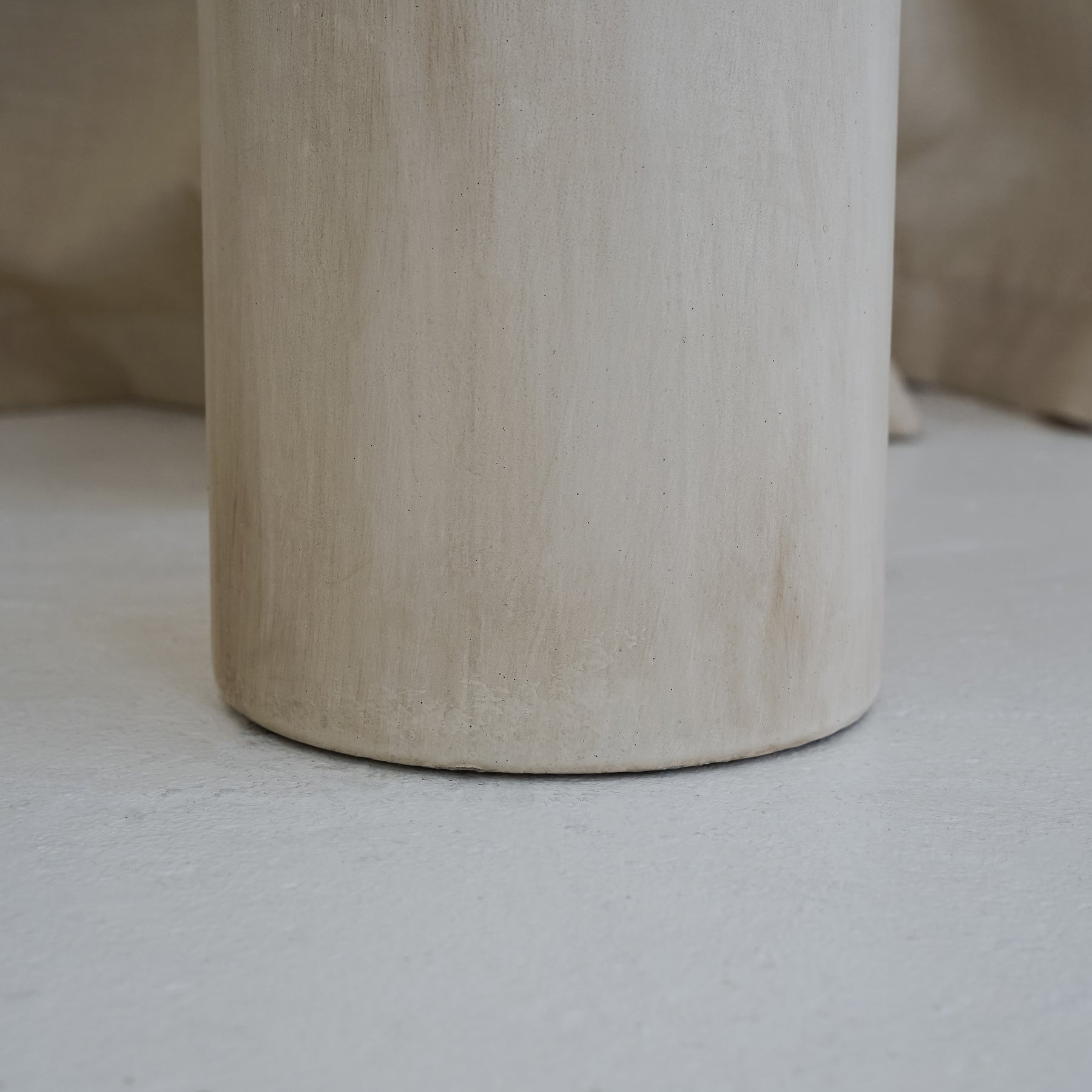 Beige textured ceramic small vase detail shot of base