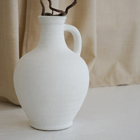 White Textured Ceramic Small Vase with fabric background