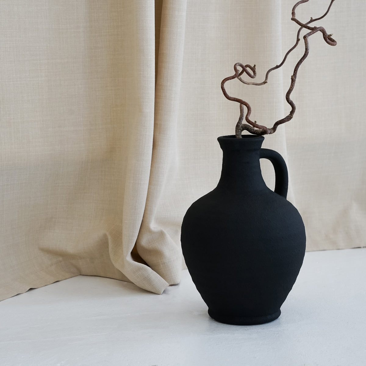 Black Textured Ceramic Small Vase with fabric background