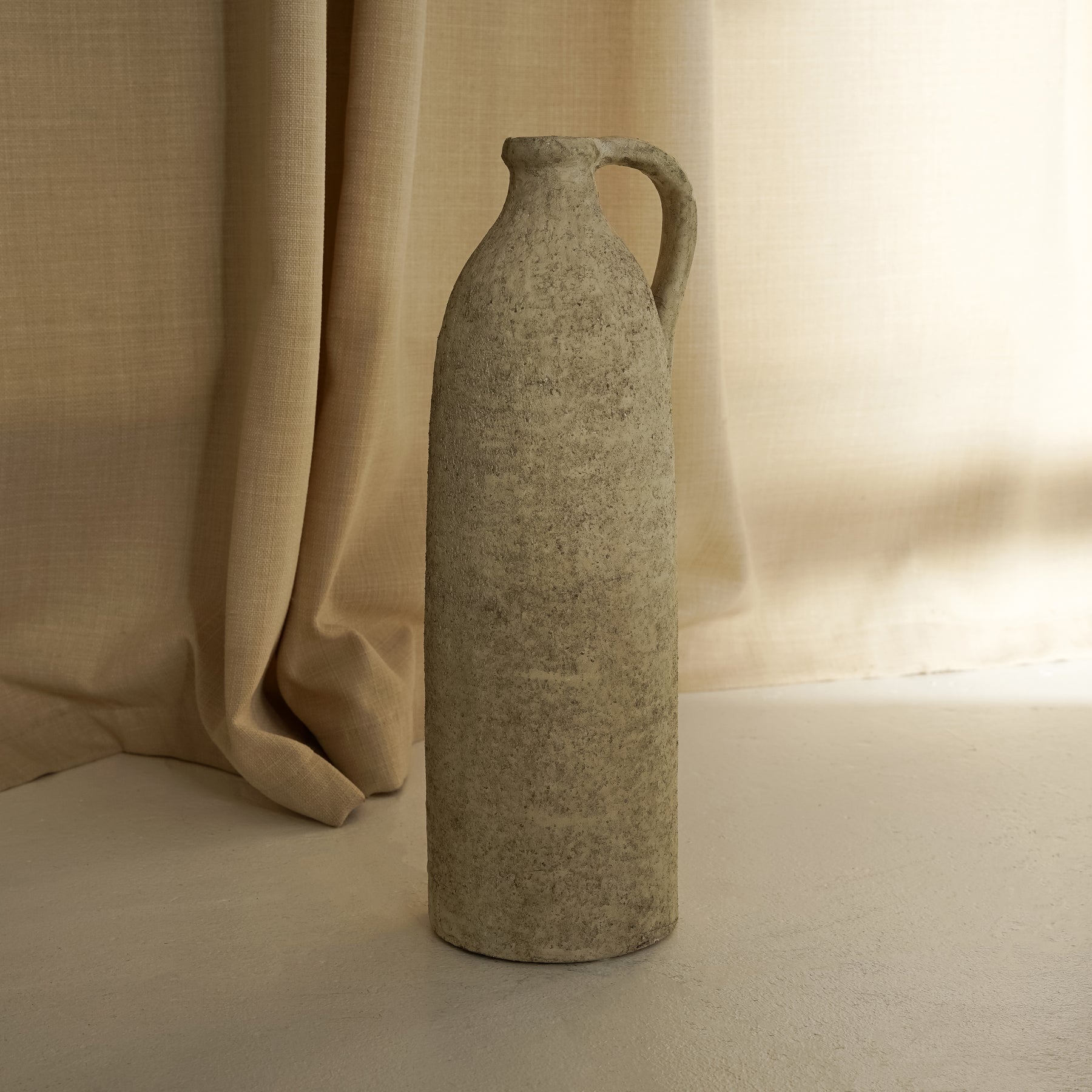 Beige Textured Terracotta Small Vase in front of fabric
