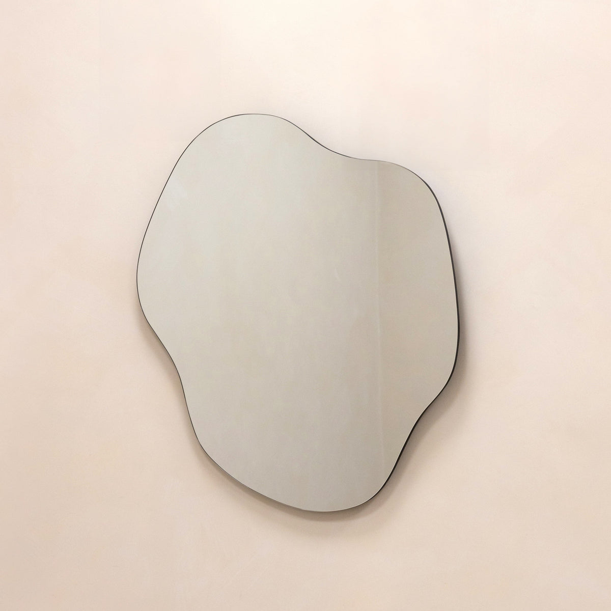 Medium Frameless Pond Mirror hanging on wall