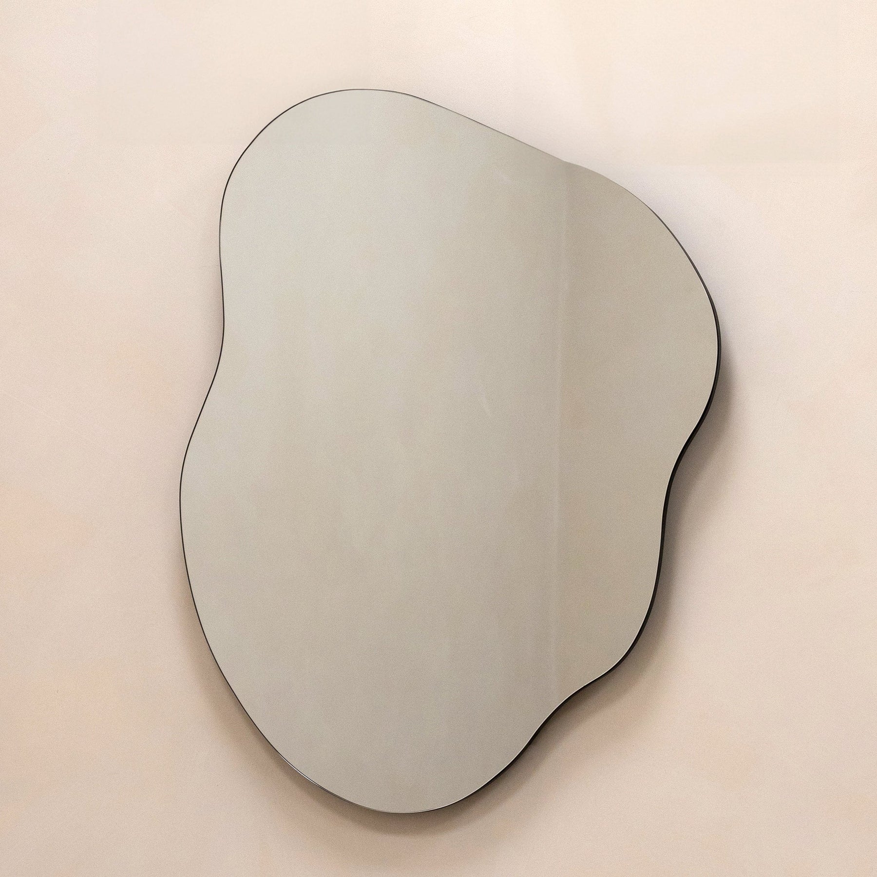 Small Frameless Pond Mirror displayed on wall, rotated