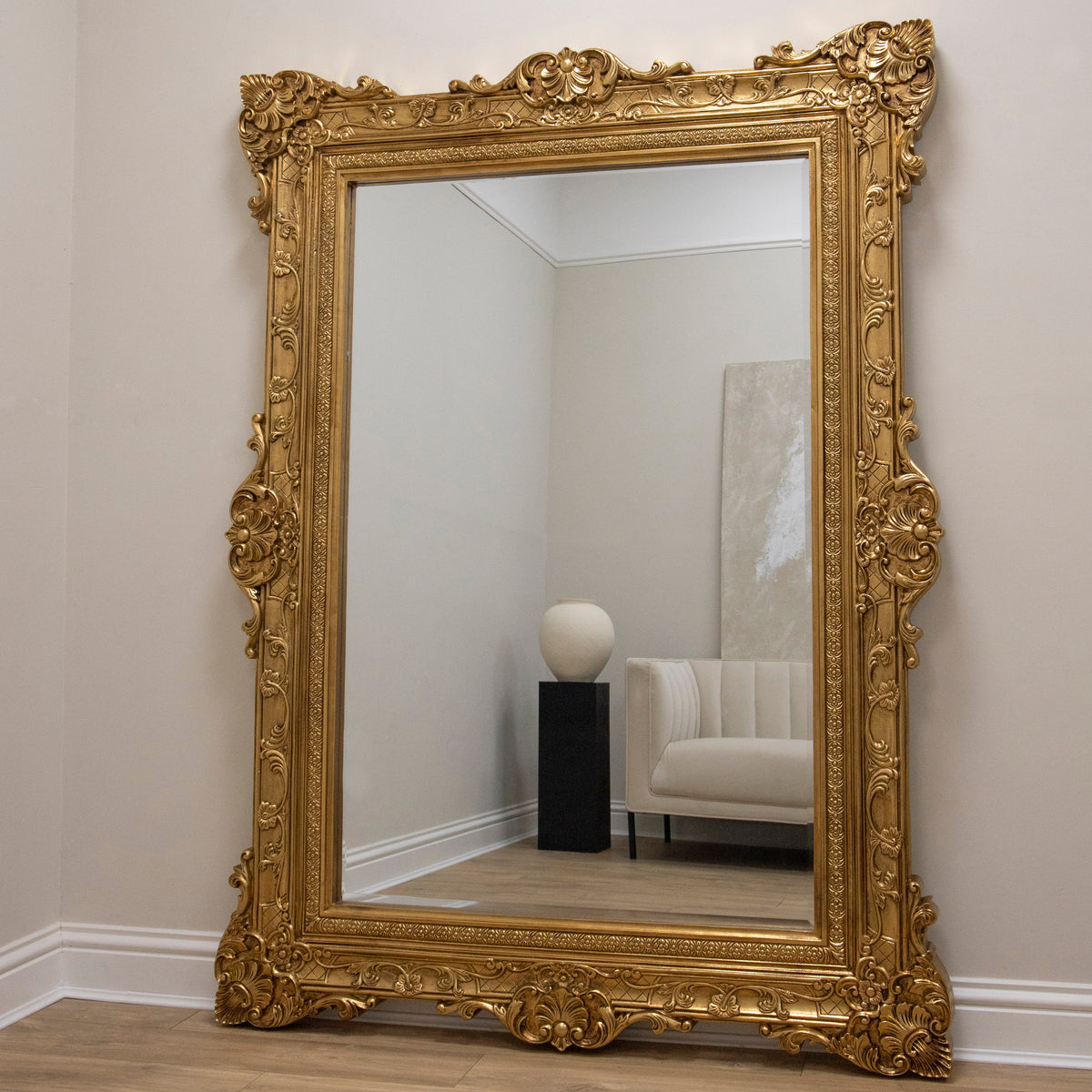 Gold Ornate Floor Mirror leaning against wall