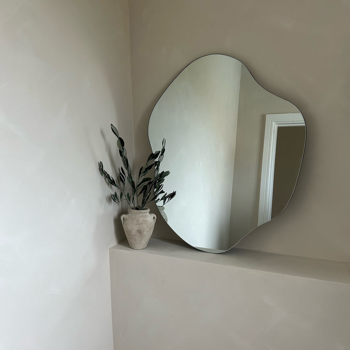 Small Frameless Pond Mirror leaning against the wall