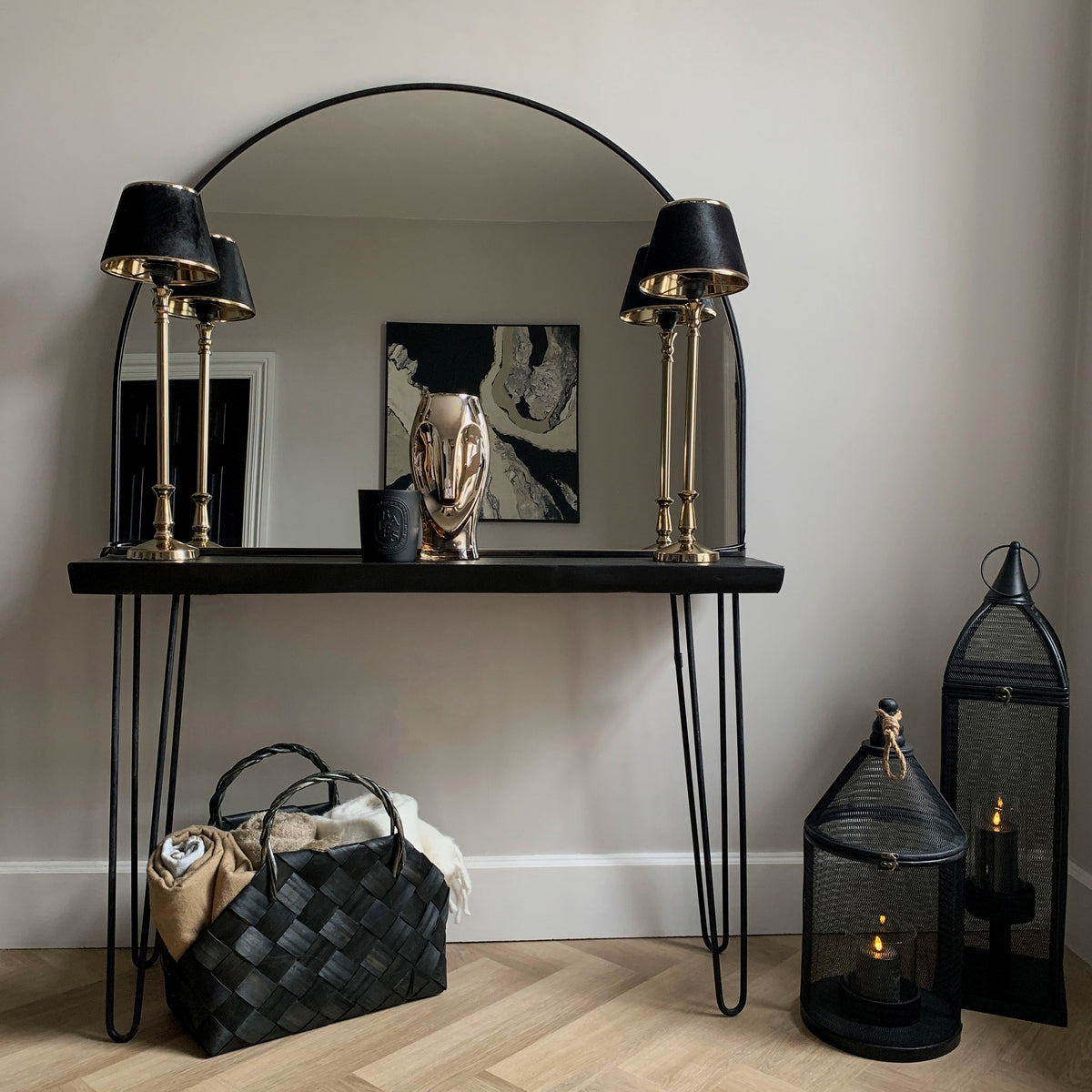 Black Wide Arched Metal Overmantle Mirror on console table