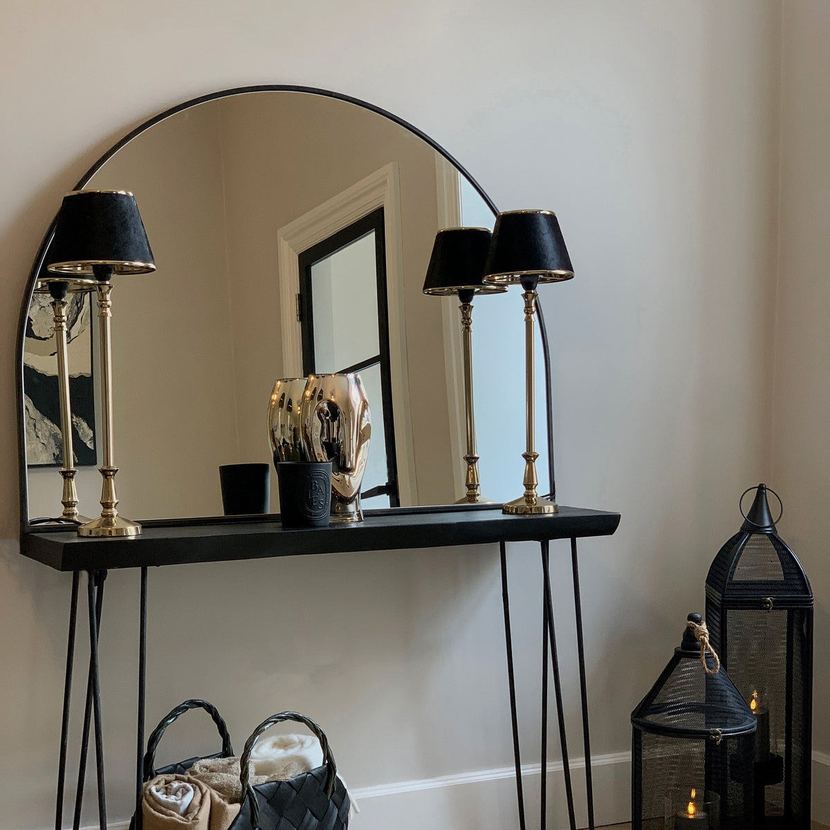 Black Wide Arched Metal Overmantle Mirror leaning against wall
