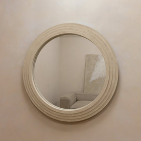 Round Concrete Wall Mirror on wall opposite sofa
