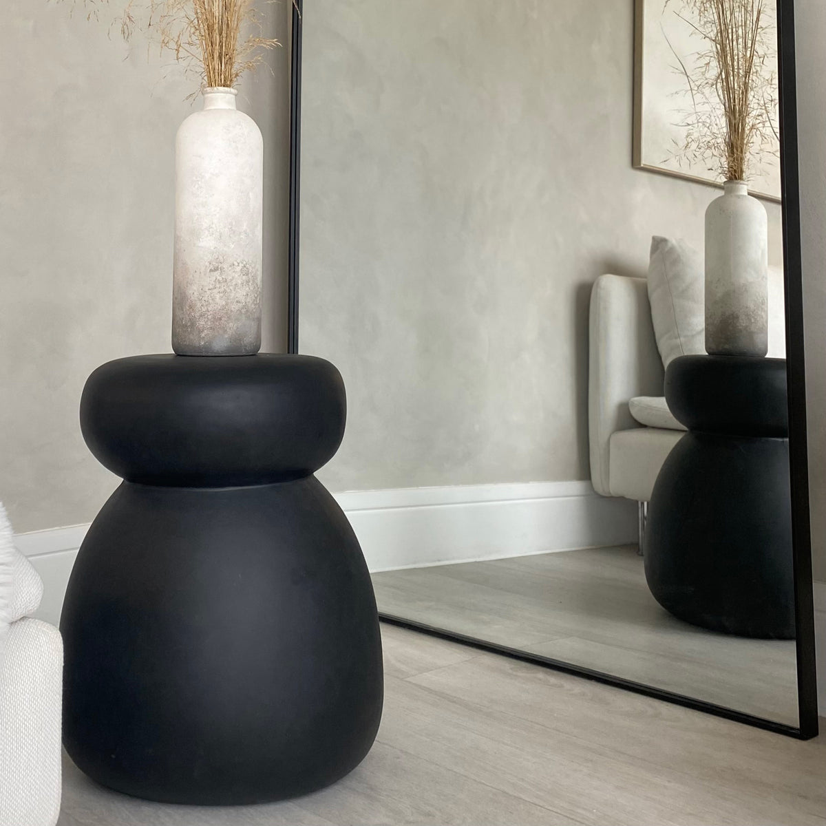 Minimal Onyx Side Table displaying tall vase