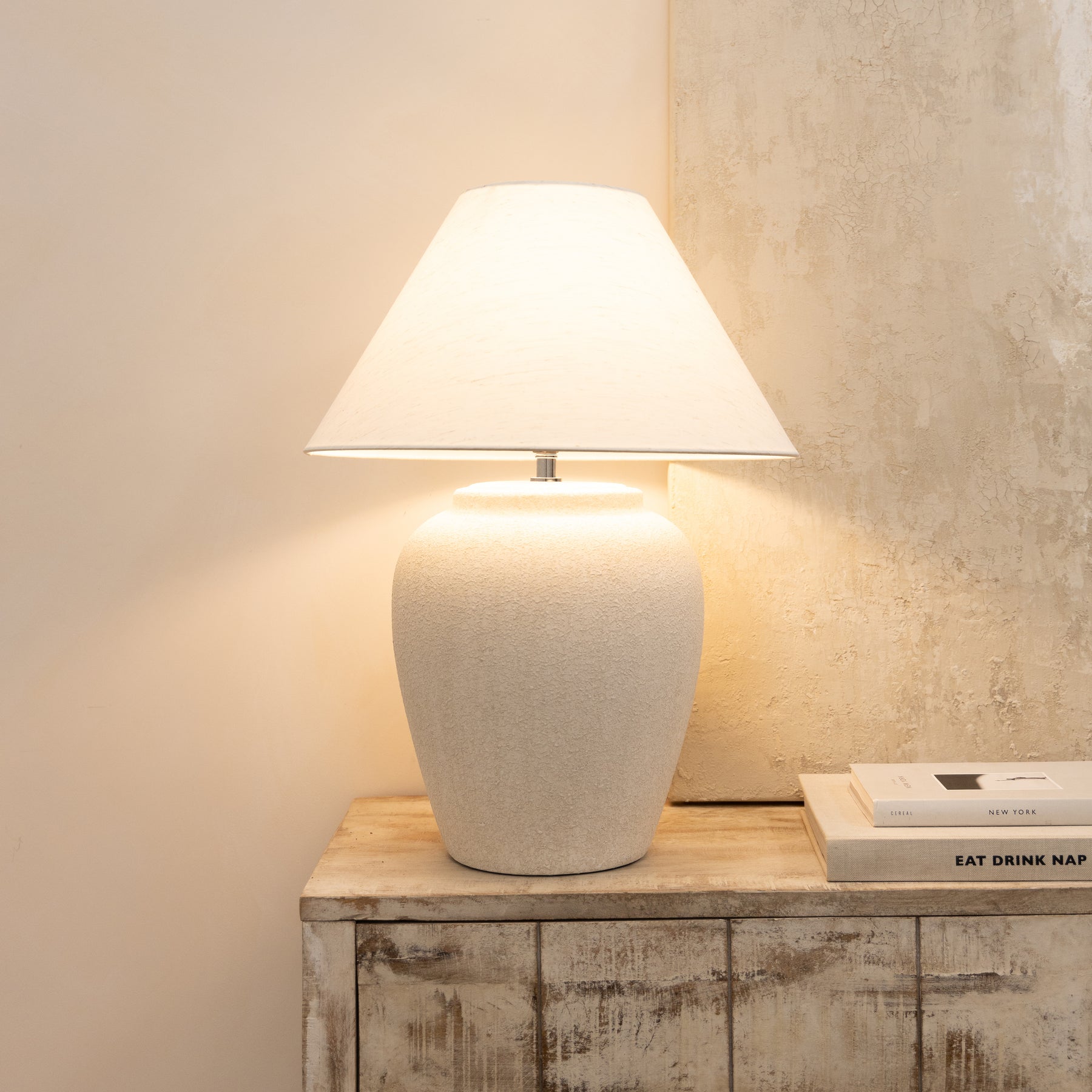 Stone Ceramic Coolie Shade Table Lamp emitting warm light