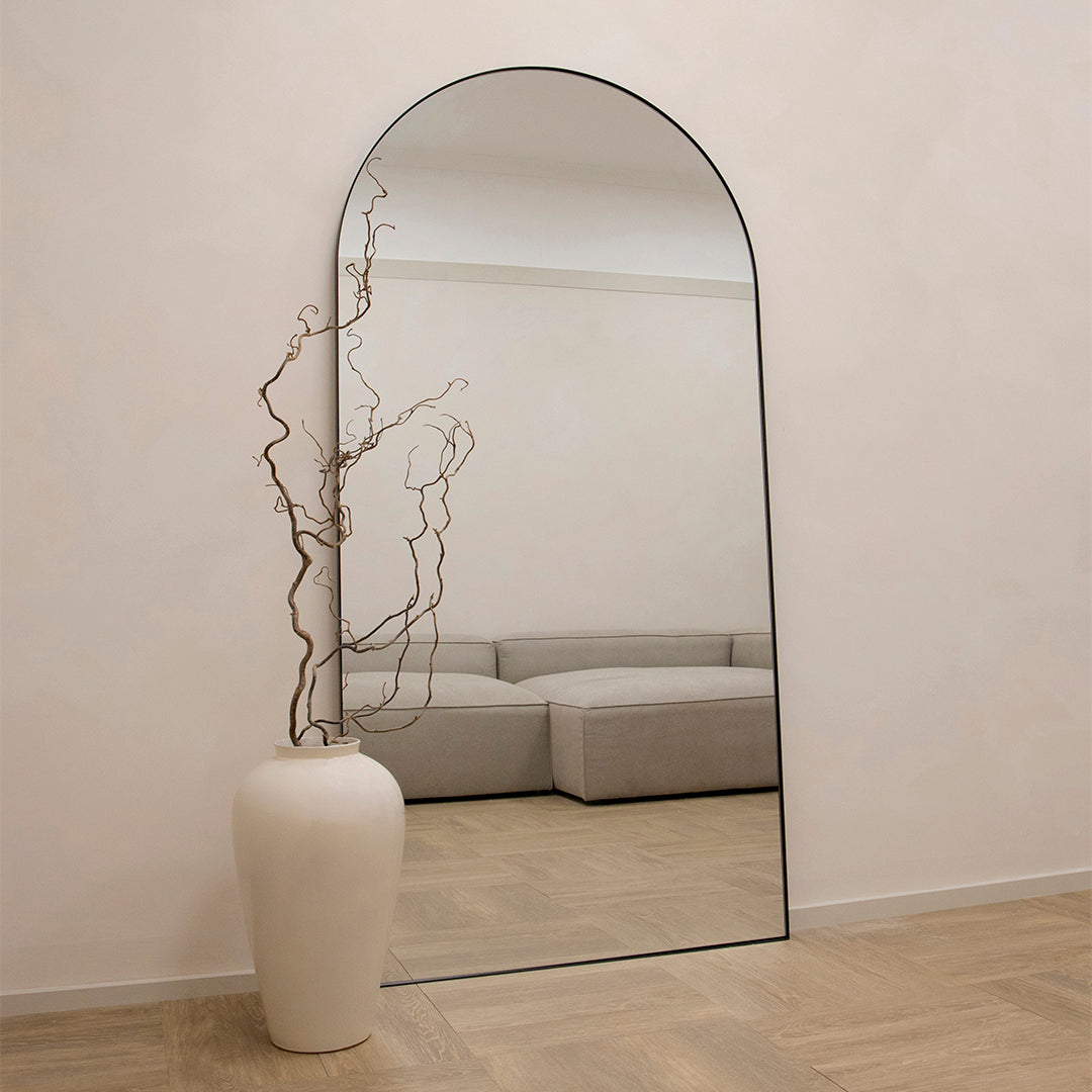 Full Length Black Arched Large Metal Mirror beside vase
