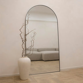 Full Length Black Arched Large Metal Mirror beside vase