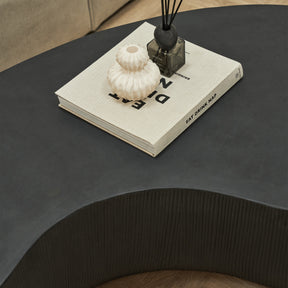 Minimal Onyx Shaped Coffee Table Large detail shot of book, incense, and ceramic vase