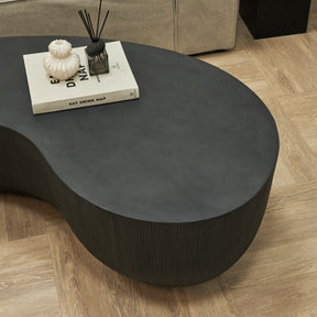 Minimal Onyx Shaped Coffee Table Large adorned with book, incense, and ceramic vase