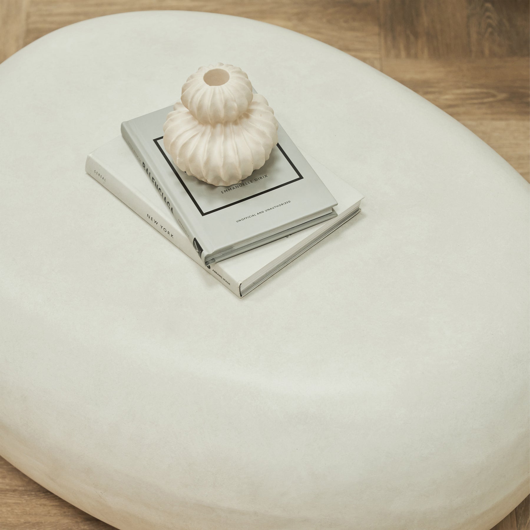 Minimal Concrete Pebble Coffee Table Large adorned with books and ceramic