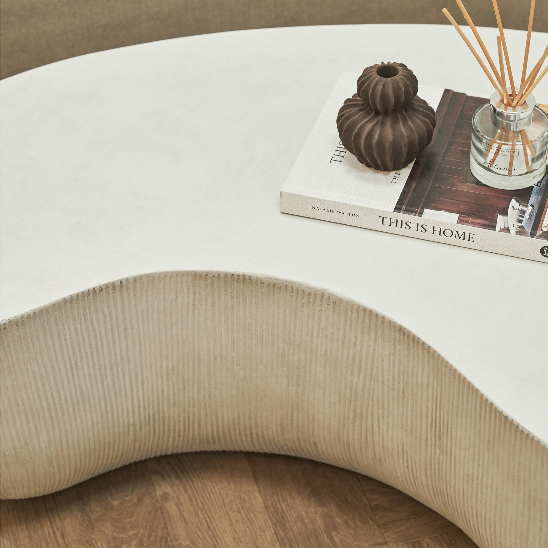 Minimal Concrete Shaped Coffee Table Large adorned with books, incense, and ceramic vase