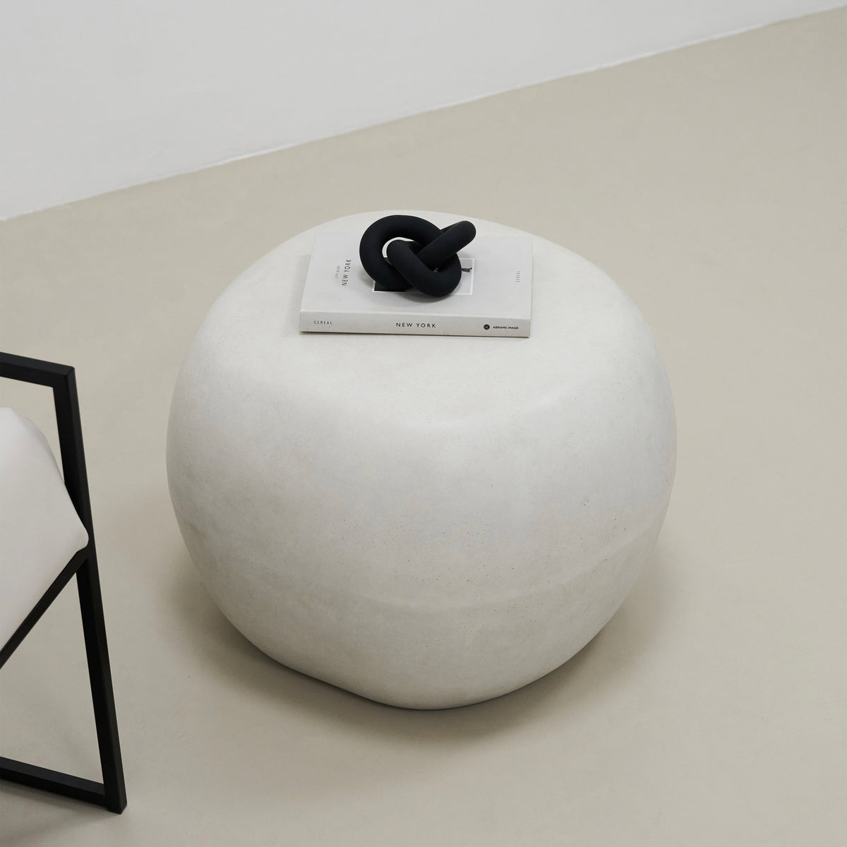 Minimal Concrete Pebble Side Table adorned with book