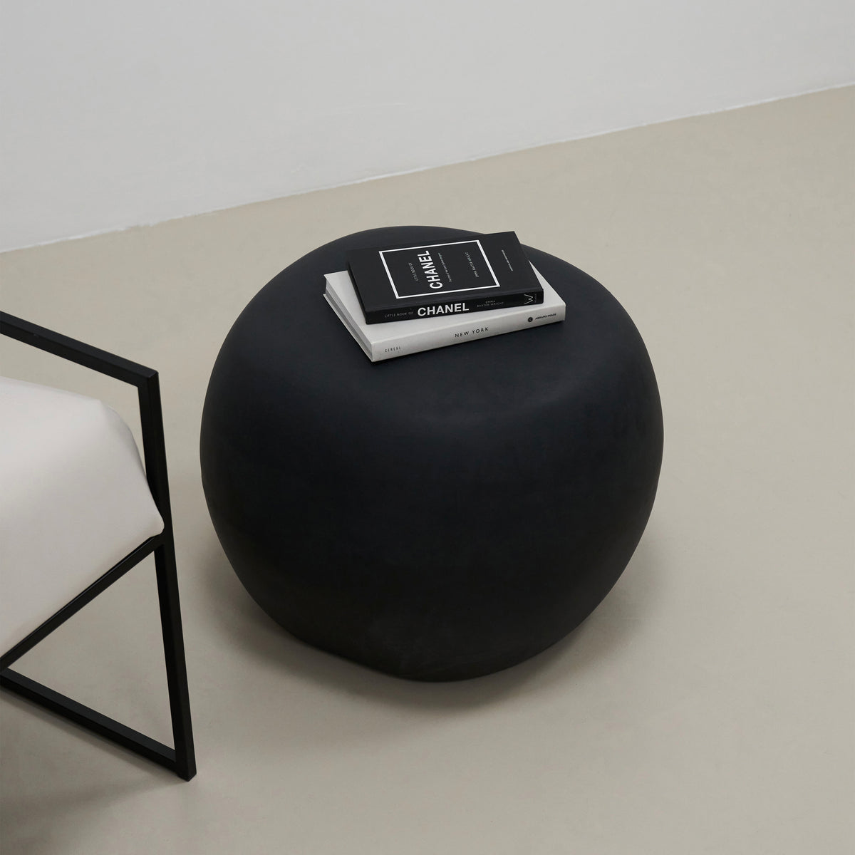 Minimal Onyx Pebble Side Table adorned with books