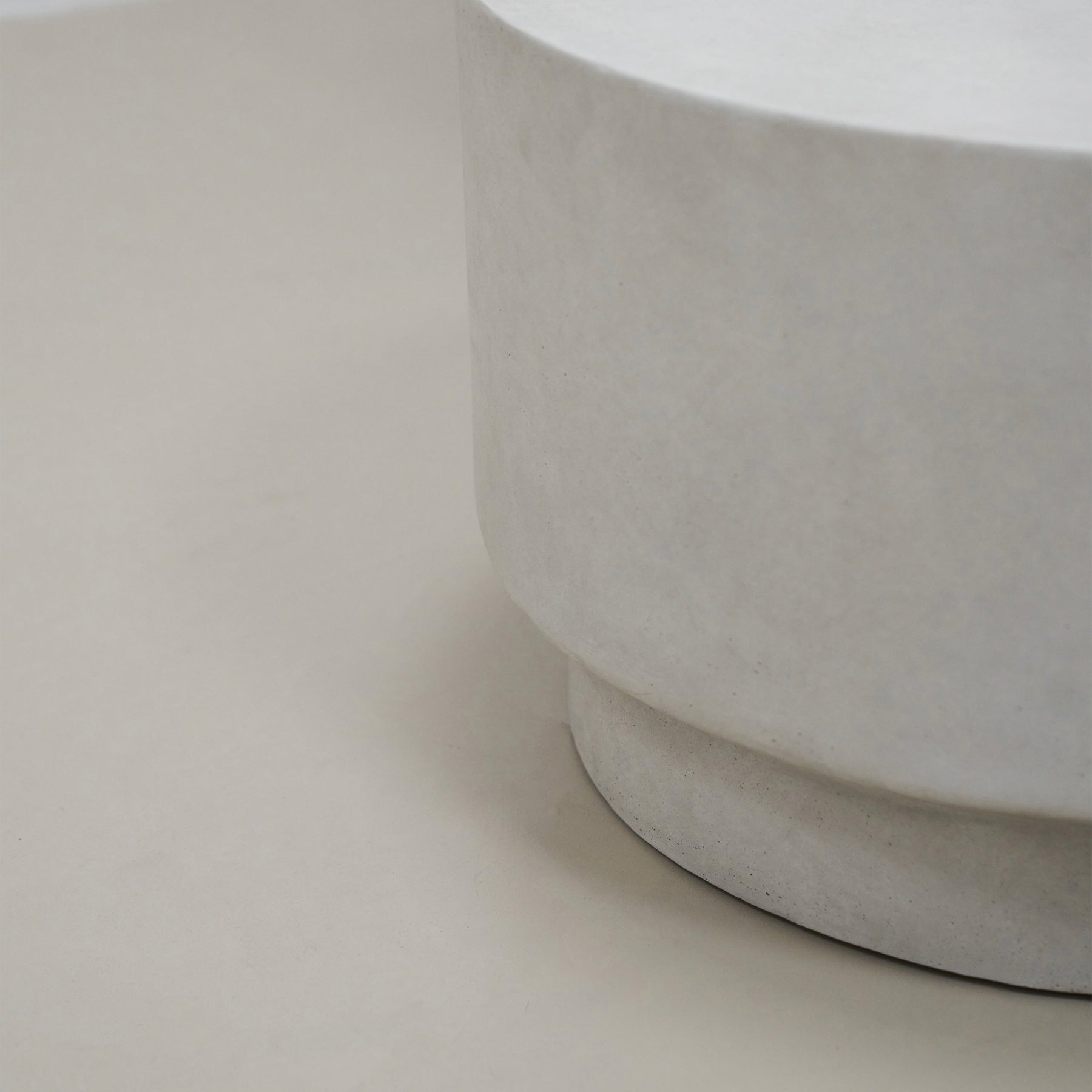 Closeup of Minimalist white concrete round coffee table