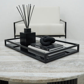 Black modern large rectangle tinted mirrored decorative tray on Artemis travertine table