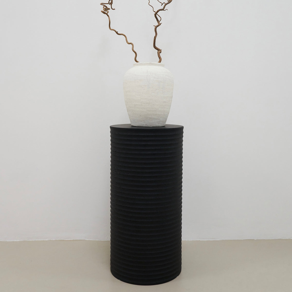 Minimal Onyx Ribbed Plinth adorned with vase