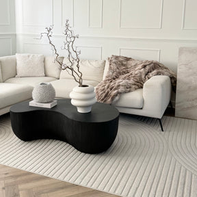 Minimal Onyx Shaped Coffee Table Large contrasting with white living room