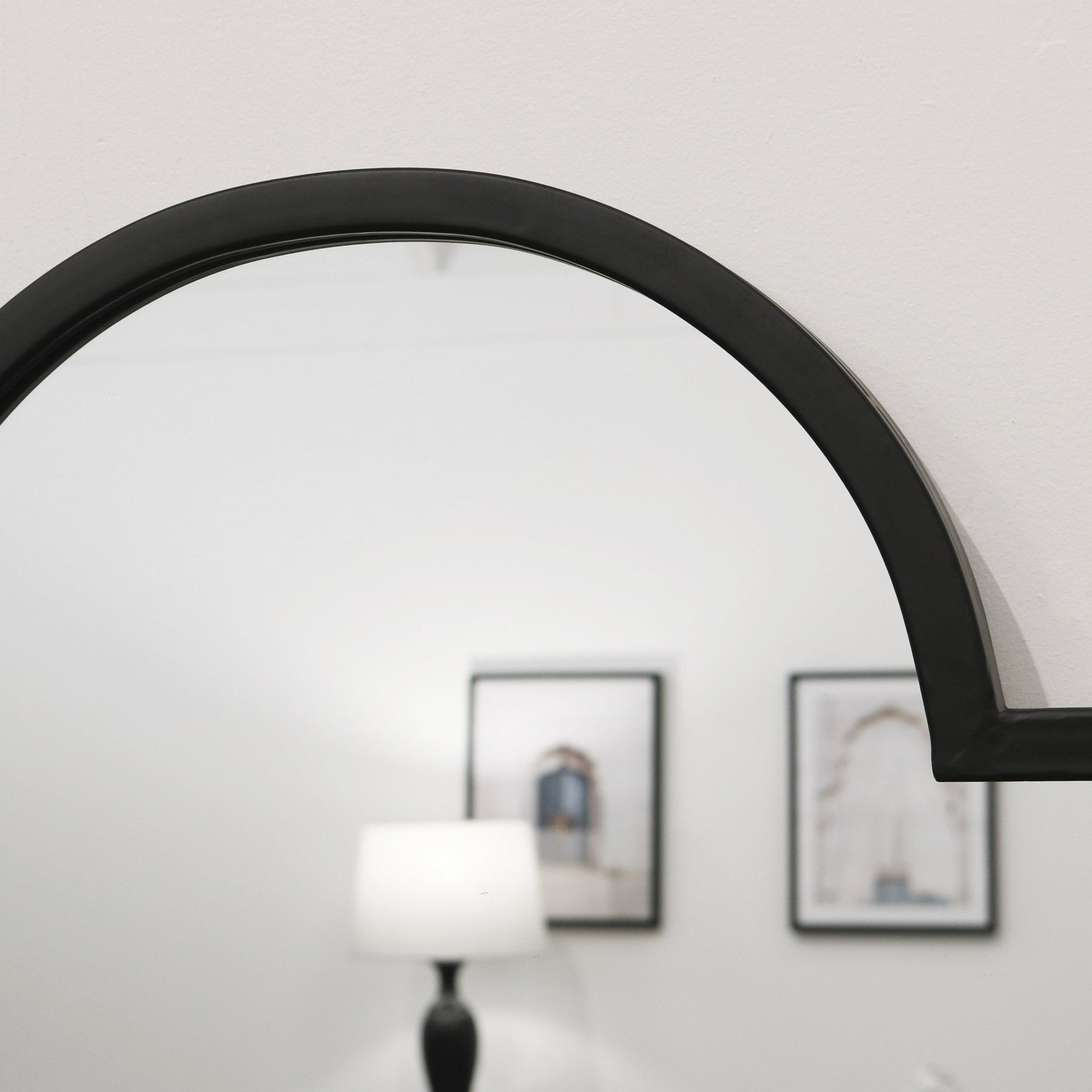 Closeup of Black industrial arched metal full length mirror