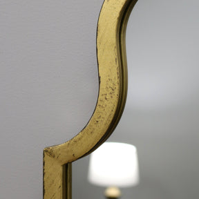 Closeup Gold industrial arched full length metal mirror