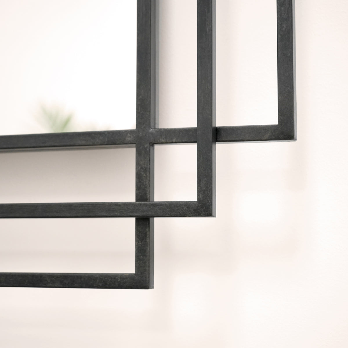Closeup of Black rectangular art deco metal mirror
