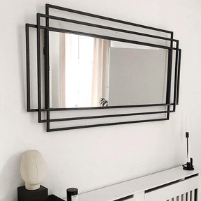 Large black rectangular metal mirror displayed on wall