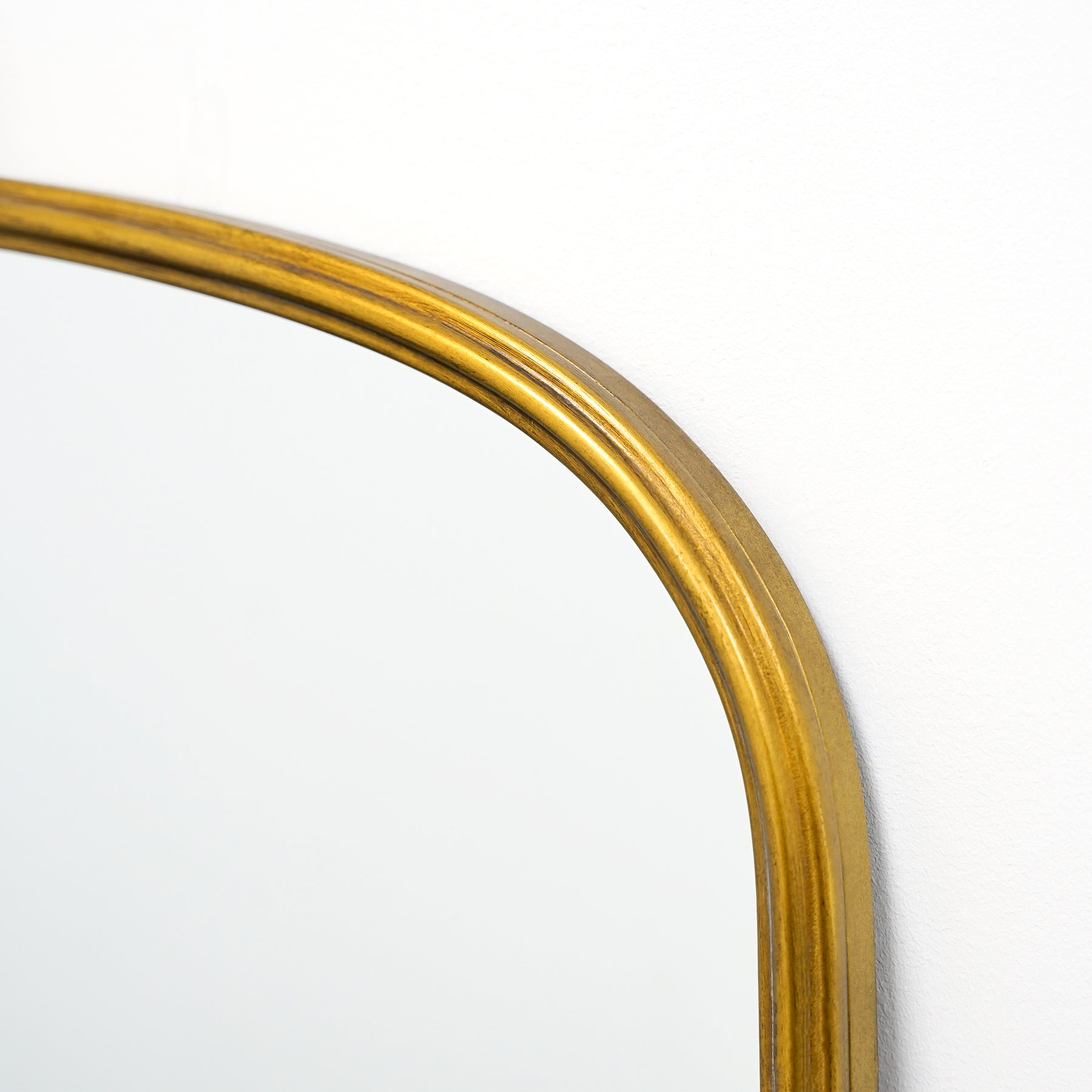 Closeup of Full length gold arched metal mirror
