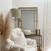 Gold industrial rectangle metal mirror displayed in lounge