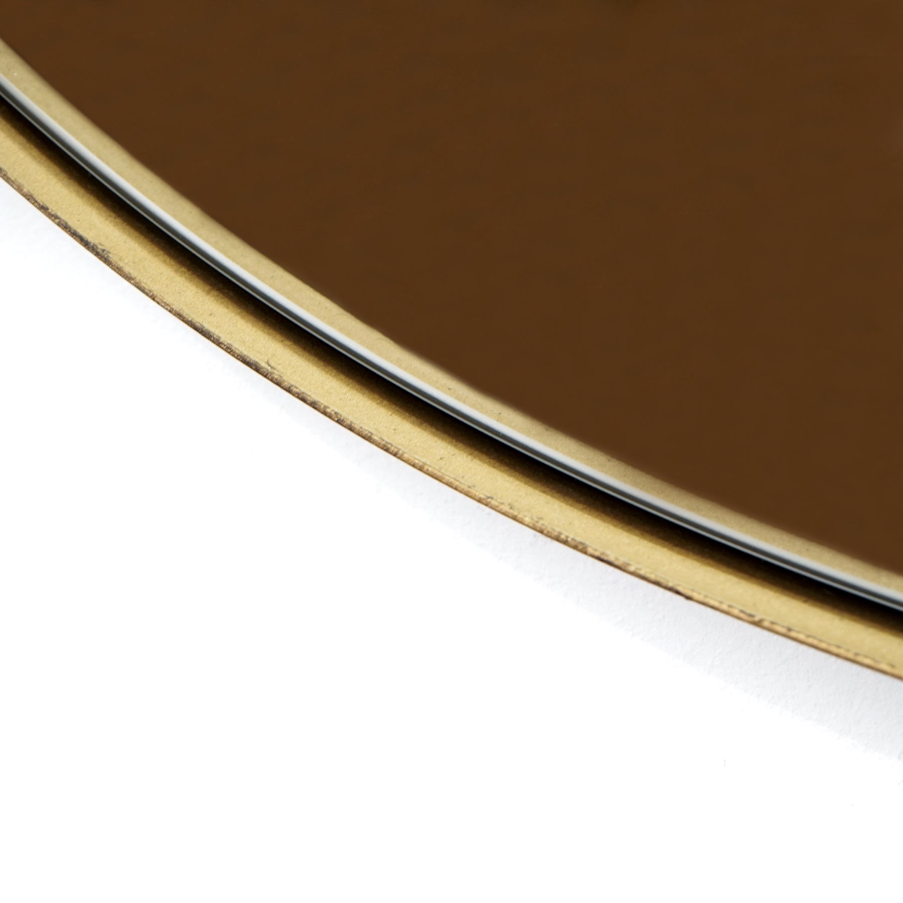 Gold metal pond shaped irregular wall mirror closeup of curves